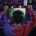 back view man winning videogame 23 2149350002