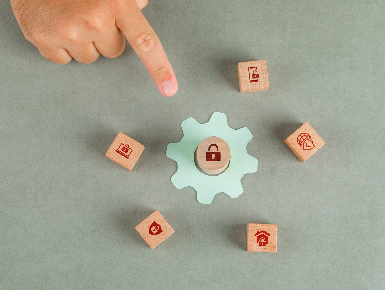 conceptual data privacy man hand pointing with wooden blocks paper settings icon
