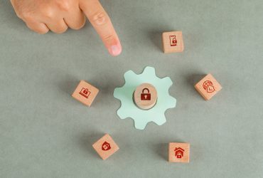 conceptual data privacy man hand pointing with wooden blocks paper settings icon
