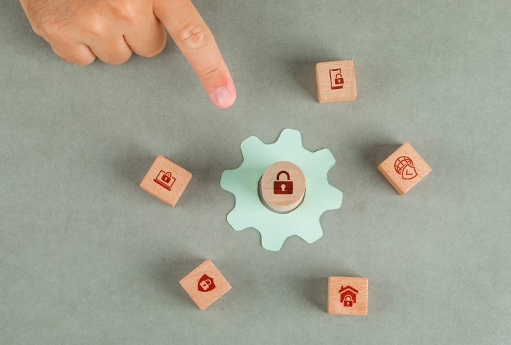 conceptual data privacy man hand pointing with wooden blocks paper settings icon