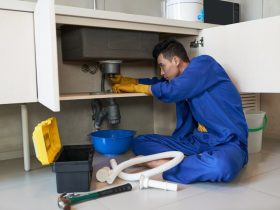 asian plumber blue overalls clearing blockage drain 1098 17773 1